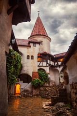 Inside Bran Castle in Transylvania. Inner yard in a summer rainy day. The dark Castle of Count...