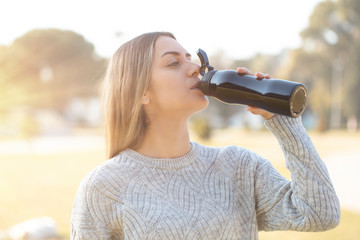 pretty young woman drinking water with flasks, healthy lifestyle