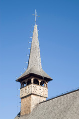 Fototapeta na wymiar Belfry of wooden orthodox church of St. Basil the Great in Curtea de Arges, Romania