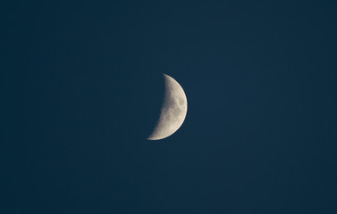 Obraz na płótnie Canvas a half moon on dark blue sky