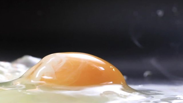 Egg fried on skillet sunny side up close up view