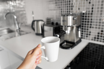 First-person view of a girl preparing delicious aromatic coffee in a coffee machine. A simple way to make coffee