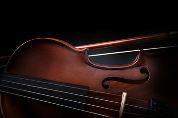 Violin detail with bow and dark background