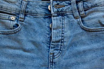 Fototapeta premium part of jeans with beautiful embossed stitching, seam, fabric texture, close-up, copy space