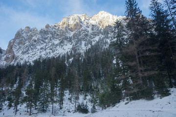 Winter landscape with mountain and trees near Green lake (Gruner see) in sunny day. Famous tourist destination for walking and trekking in Styria region, Austria
