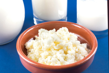 Homemade fermented beverage kefir with kefir graiuns on a trendy blue background, concept of natural fermented food and intestinal health