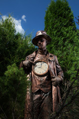 Stylized magic character of fairytale bronze watch repairer.