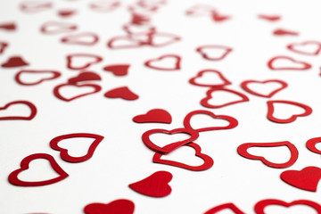 Valentines day heart. Heart shape red confetti splash on white background. Happy Valentines Day greeting card background.