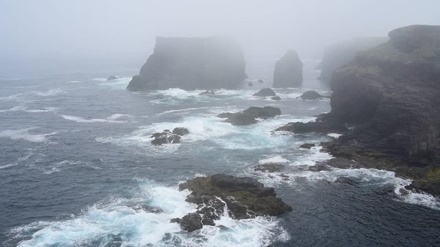 Sea stacks and cliffs in the mist at Eshaness / Esha Ness, peninsula in Northmavine on the island of Mainland, Shetland Islands, Scotland, UK