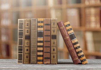 Stack old retro vintage books on wooden desk