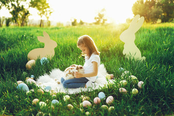 the girl with the rabbit. happy little girl holding cute fluffy Bunny. Friendship with Easter...