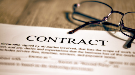 White paper and pen, contract template on the table