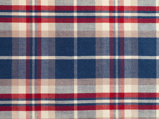  fabric with a checkered pattern of blue, red, white. close-up