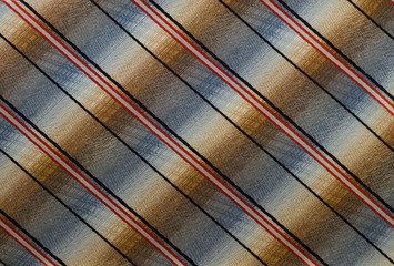  multi-colored fabric with black, white and red stripes diagonally