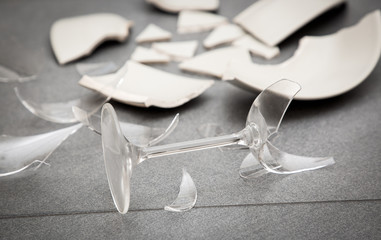 Broken Plate or broken water glass on the on the floor in the kitchen The concept of accidents in...