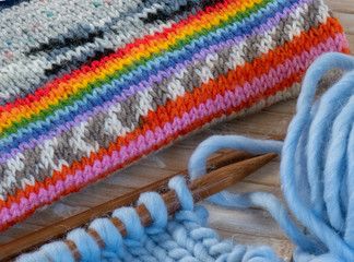 brightly coloured hand knitting on needles