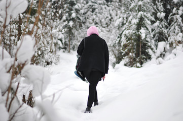 Girl in a snow-covered mountain forest