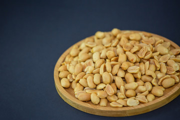 Peanuts Nut mixed salt in a wooden plate is Protein food and healthy food for diet food on a black background.