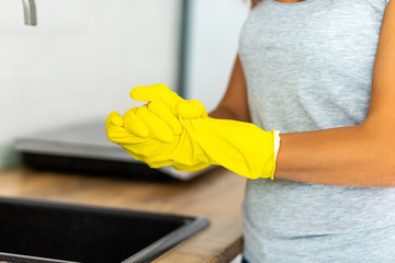 Cropped shot of female hands in rubber gloves for the protection of the skin from chemicals.