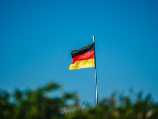 German flag. The German flag blowing in the wind on a clear blue day in spring.