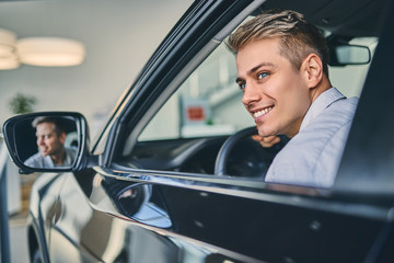 Caucasian man sitting in a new car.