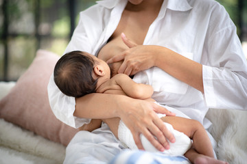 Fototapeta na wymiar Adolescent mother is breastfeeding a baby.