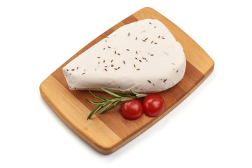 Goat cheese with cumin seeds, isolated on white background
