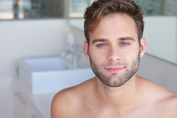 Young man looking fresh and clean in modern bathroom