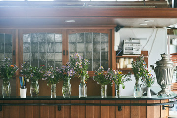 Flowers in vases at the bar.