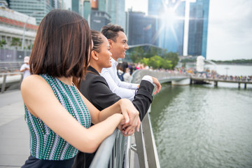Fototapeta premium Group of Three Asian Friends enjoy the visit of a big metropolitan city