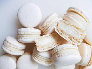 French dessert macaron with vanilla and white chocolate ganache on a white background