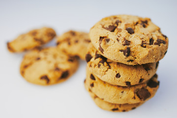 pile of chocolate cookies against white background with copy space