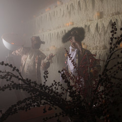 Actors in Steam punk masks and antique costumes indoor.