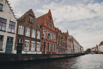 Fototapeta na wymiar Colourful houses on canal in Bruges, Belgium 