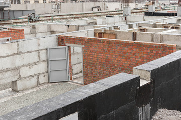 The construction of a multi-storey building. Construction machinery or site.