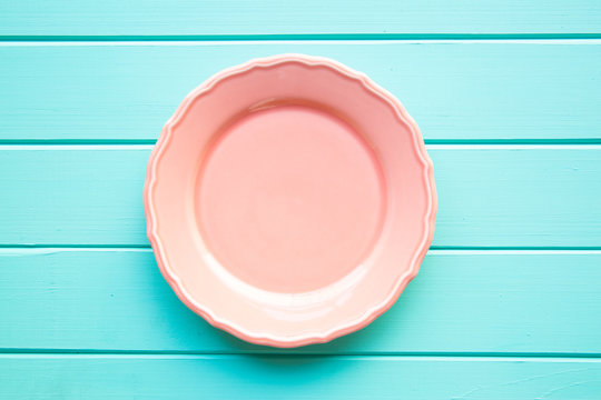 Empty Pink Plate On Turquoise Background, Copy Space, Top View. 