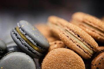 Fototapeta na wymiar Delicious and beautiful brown and gray macaroons on sale. Copy space.