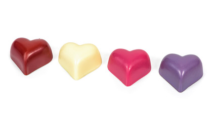 Colorful heart shaped chocolates on white background