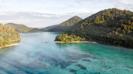 Fototapeta premium Mountains and coral reef on a wonderful seascape scenario, aerial view