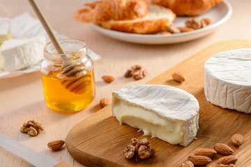 Brie cheese with runny texture, almonds, walnuts and honey