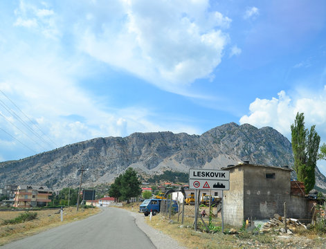 Road signs at the entrance to the town Leskovik, Albania.