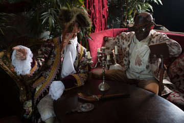 Actors in Steam punk masks and antique costumes indoor.