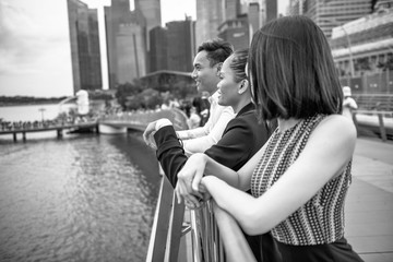Fototapeta na wymiar Group of Three Asian Friends enjoy the visit of a big metropolitan city