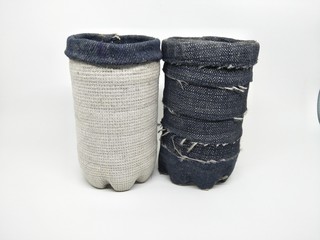 Handmade craft recycle bottle and jeans become pencil stationary case desk. Tube box shape with top hole. Decoration with sand, button and bordir  embroidery. Work process cut sewn taped glued dry. 