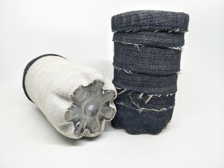 Handmade craft recycle bottle and jeans become pencil stationary case desk. Tube box shape with top hole. Decoration with sand, button and bordir  embroidery. Work process cut sewn taped glued dry. 