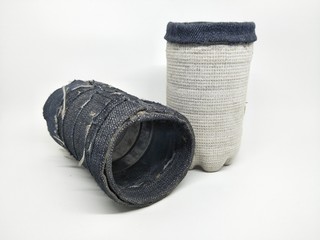 Handmade craft recycle bottle and jeans become pencil stationary case desk. Tube box shape with top hole. Decoration with sand, button and bordir  embroidery. Work process cut sewn taped glued dry. 