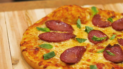 Appetizing hot pepperoni pizza lies on a tray. Appetizing hot pepperoni pizza lies on a tray. Close-up. 4k