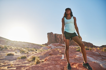 athletic african american woman hiking through desert at vallet of fire park