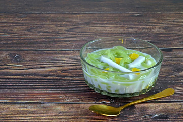 Cendol : Cendol is an iced sweet dessert, contains droplets of green pandan rice flour jelly, mixed with sliced jackfruit, young coconut meat in coconut milk and palm sugar syrup. Selective focus.