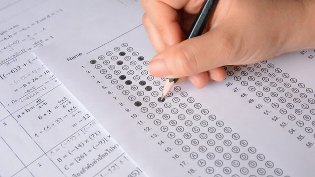 the student fills in answers on the standardized multiple choice test
